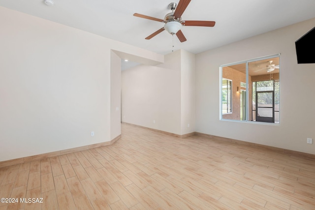 spare room featuring ceiling fan and light wood-type flooring