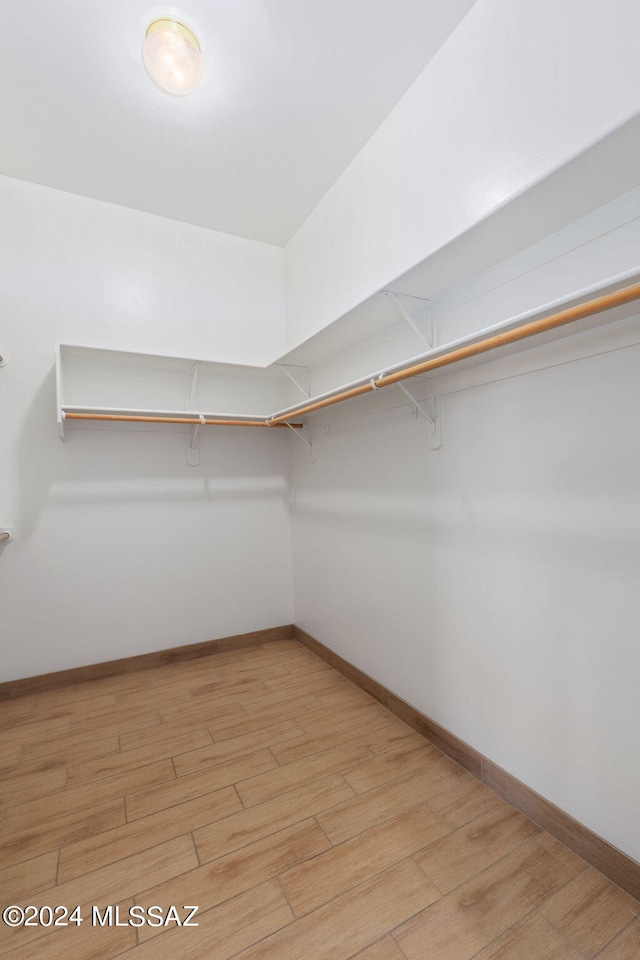 walk in closet featuring light hardwood / wood-style flooring