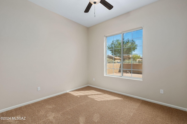 spare room with carpet and ceiling fan