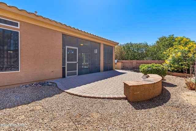 view of patio with a sunroom