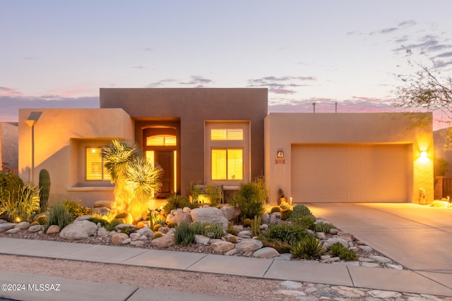 adobe home featuring a garage