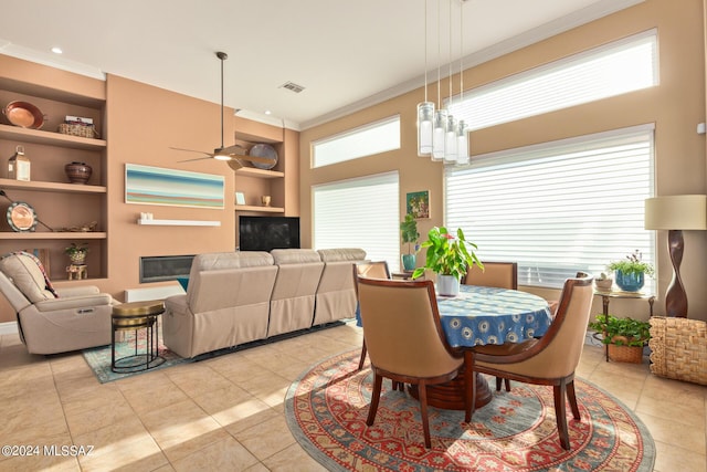 dining space with ornamental molding, light tile patterned flooring, visible vents, ceiling fan, and built in shelves