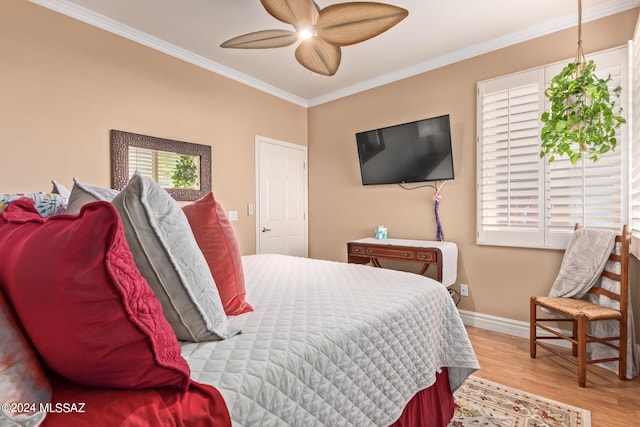 bedroom featuring ceiling fan, crown molding, light hardwood / wood-style floors, and multiple windows