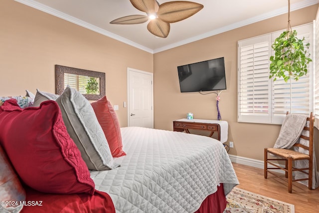 bedroom with wood finished floors, ceiling fan, baseboards, and ornamental molding