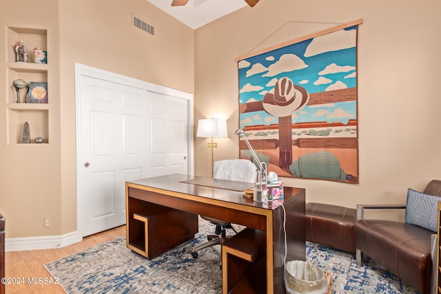 home office featuring light hardwood / wood-style floors and ceiling fan