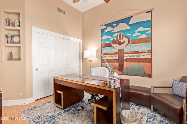 home office featuring visible vents, baseboards, a ceiling fan, and wood finished floors