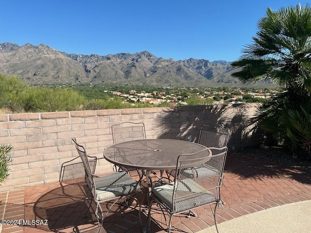 view of patio / terrace featuring a mountain view and outdoor dining area