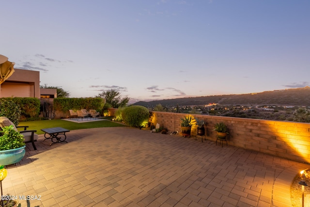 view of patio terrace at dusk