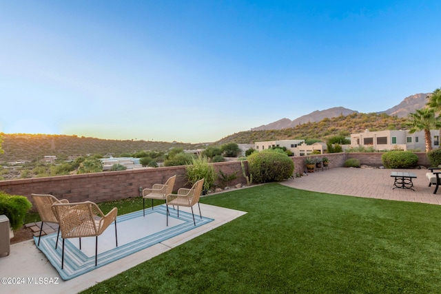 view of yard featuring a patio area and a mountain view