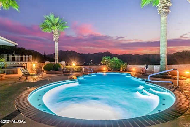 pool at dusk with a patio