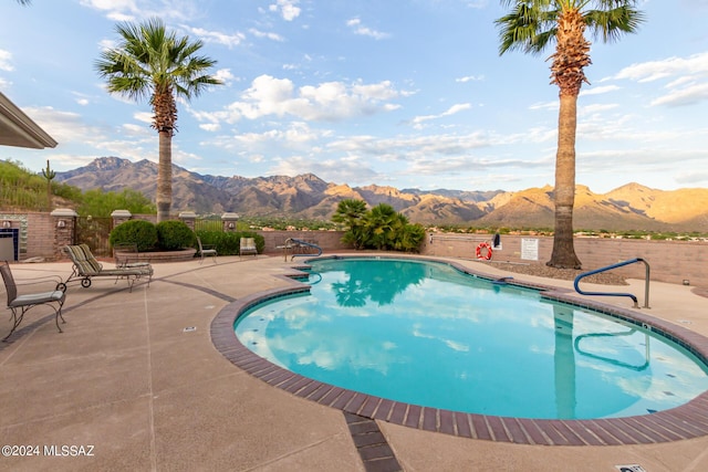 view of pool featuring a mountain view, a fenced in pool, and a patio area