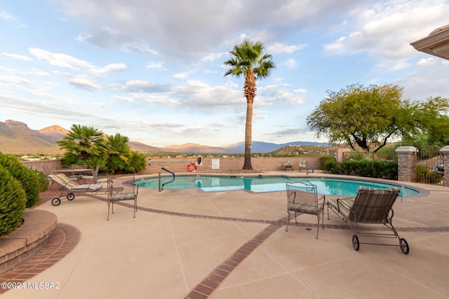 view of pool featuring a patio area, a mountain view, fence, and a fenced in pool