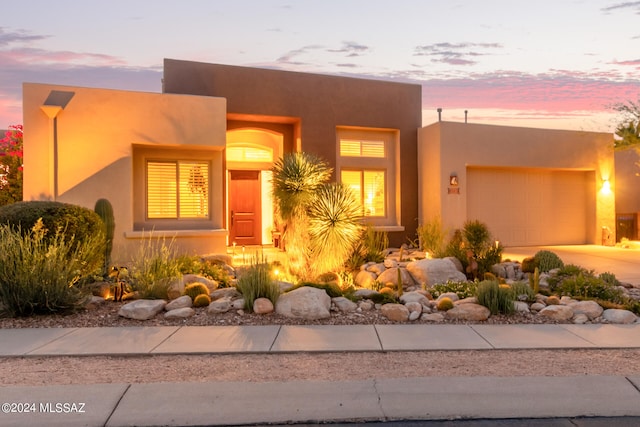 pueblo-style home with a garage