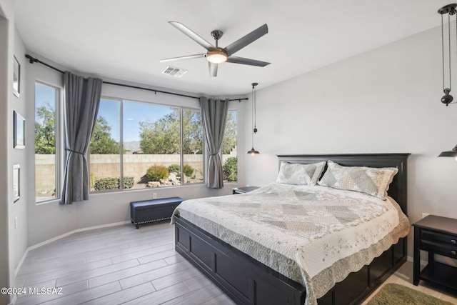 bedroom with light wood-type flooring and ceiling fan