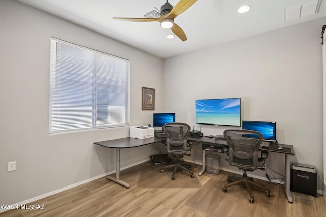 home office featuring hardwood / wood-style floors and ceiling fan