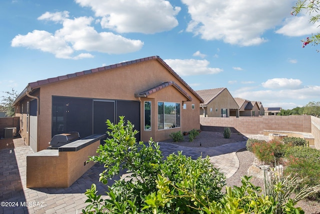 rear view of house featuring a patio and central AC unit