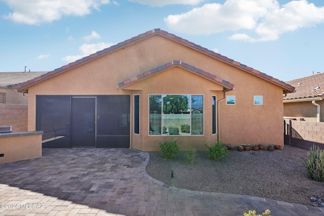 view of front of property with a patio and a sunroom