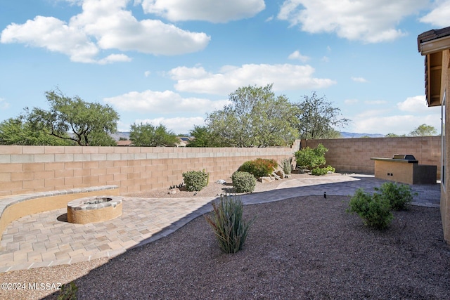 view of yard featuring a patio and an outdoor fire pit