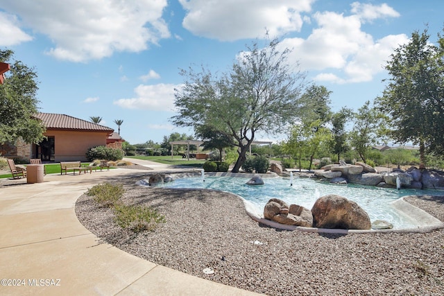 view of swimming pool with a patio area and pool water feature