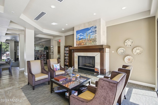 living room featuring a tile fireplace