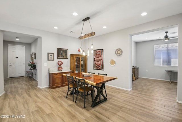 dining space featuring ceiling fan and light wood-type flooring