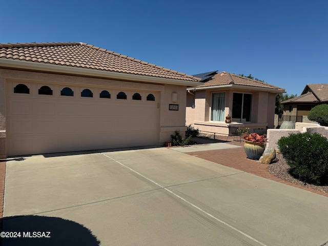 mediterranean / spanish-style home with a garage