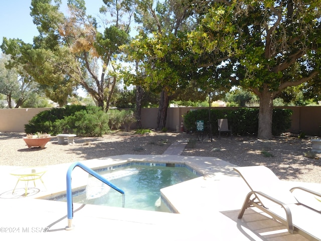 view of pool with an in ground hot tub