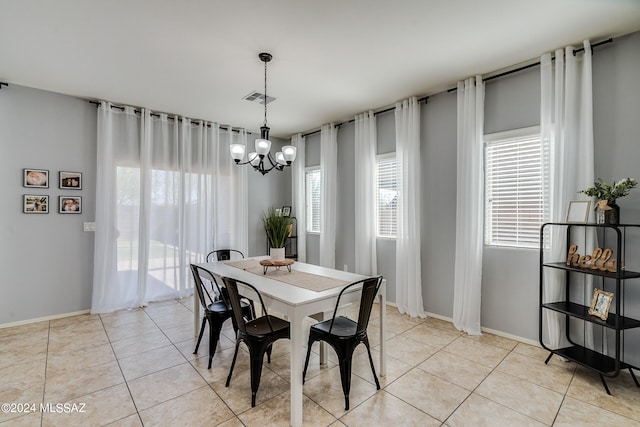 tiled dining area with a chandelier