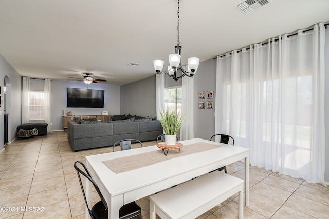 dining area featuring ceiling fan with notable chandelier and light tile patterned floors