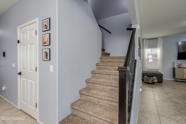 staircase featuring tile patterned flooring