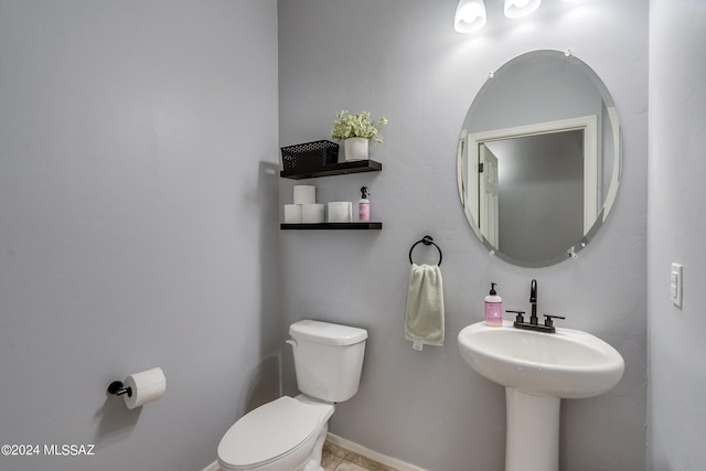 bathroom featuring toilet and tile patterned flooring