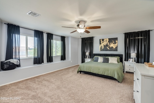 bedroom featuring light colored carpet and ceiling fan