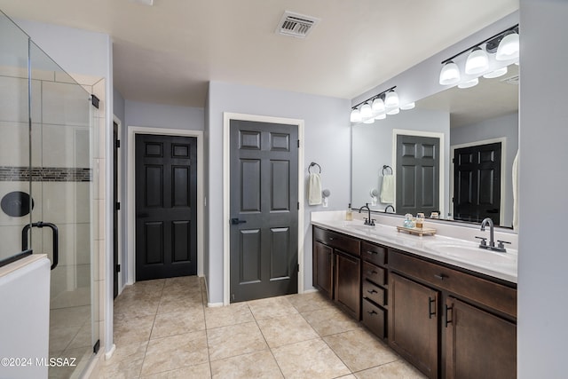 bathroom featuring vanity, an enclosed shower, and tile patterned flooring