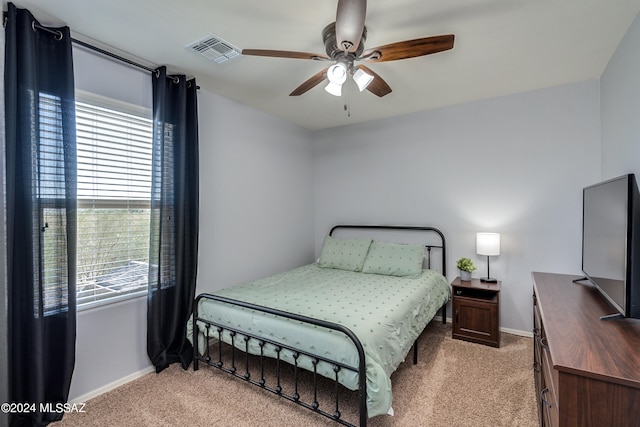 bedroom featuring light colored carpet and ceiling fan