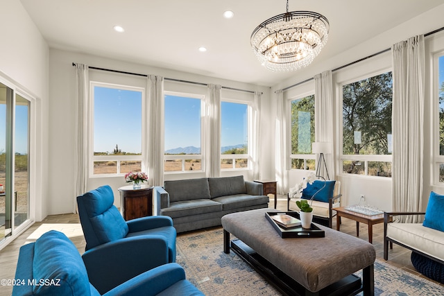 sunroom / solarium featuring a chandelier