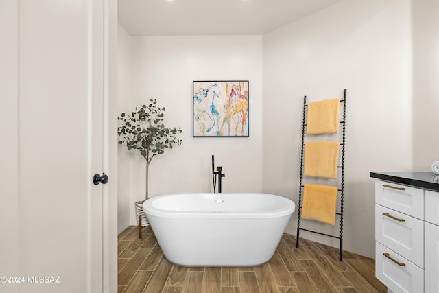 13123 E Molokai Ln, Vail, AZ 85641 - bathroom featuring a freestanding tub and wood finish floors