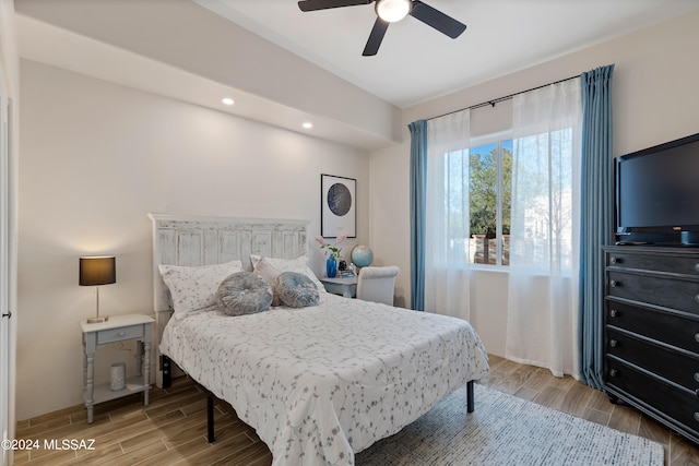 bedroom with ceiling fan and hardwood / wood-style flooring