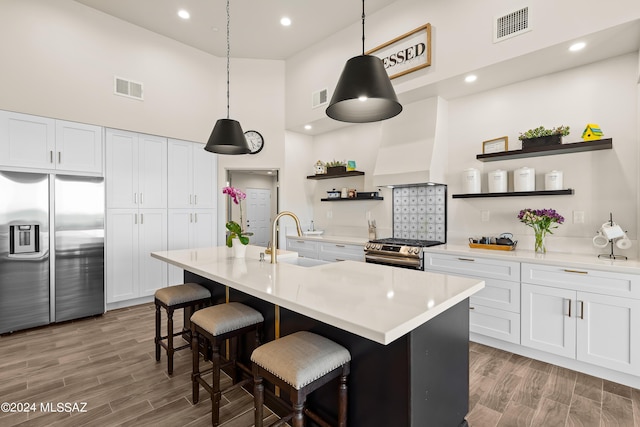 13123 E Molokai Ln, Vail, AZ 85641 - kitchen featuring open shelves, appliances with stainless steel finishes, a sink, a towering ceiling, and visible vents
