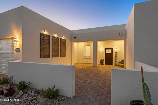 property exterior at dusk with a garage