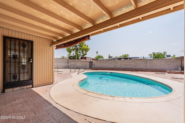 view of swimming pool with a patio area