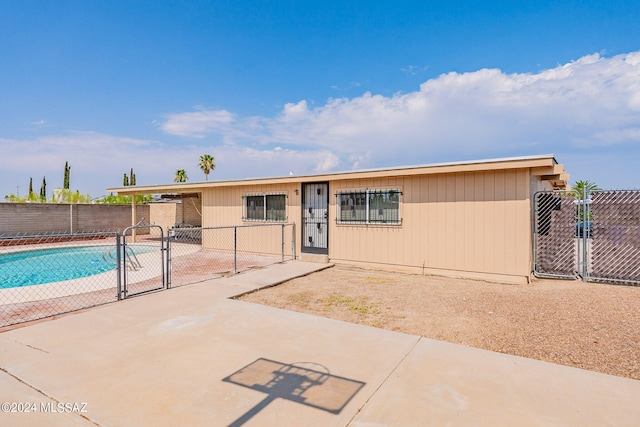 view of front of house with a fenced in pool