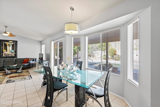 tiled dining area with vaulted ceiling