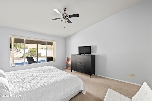 carpeted bedroom featuring ceiling fan and vaulted ceiling