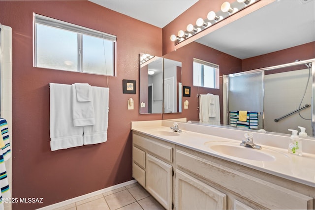 bathroom featuring vanity, a shower with shower door, and tile patterned floors