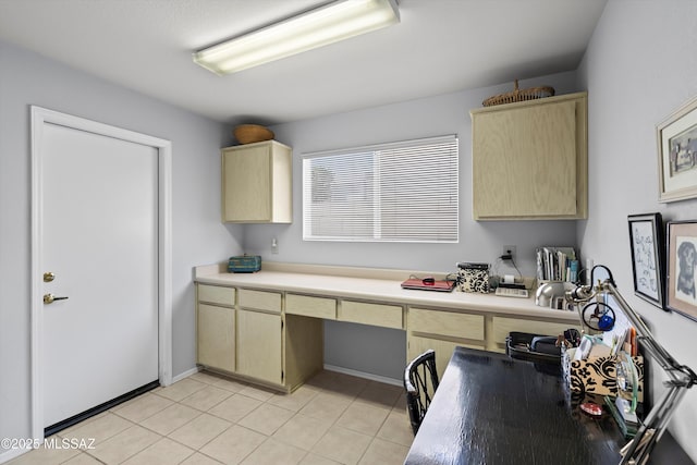 kitchen with light tile patterned floors and built in desk