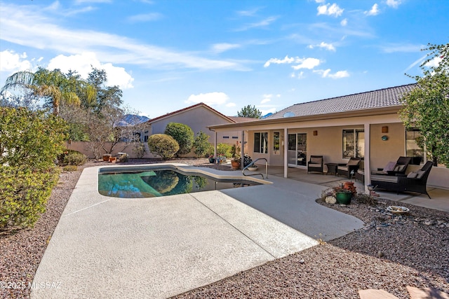 view of pool featuring an outdoor living space and a patio area