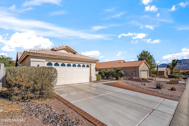 view of front of home with a mountain view and a garage