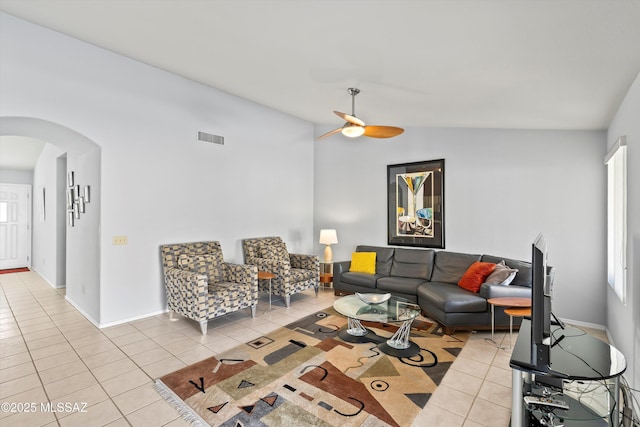 living room featuring ceiling fan, light tile patterned floors, and lofted ceiling