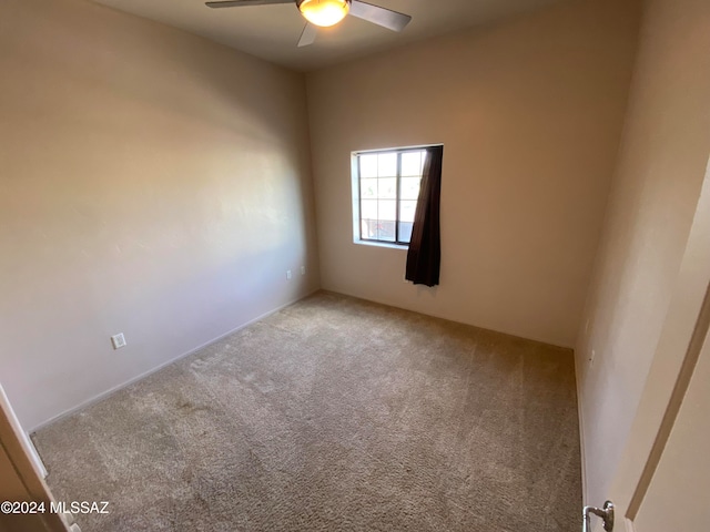 unfurnished room featuring ceiling fan and carpet flooring