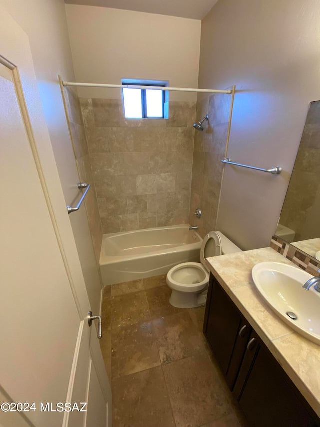 full bathroom with tiled shower / bath combo, vanity, and toilet